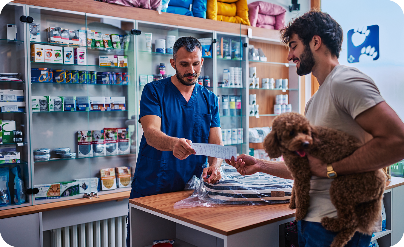 Man with dog at veterinary clinic counter